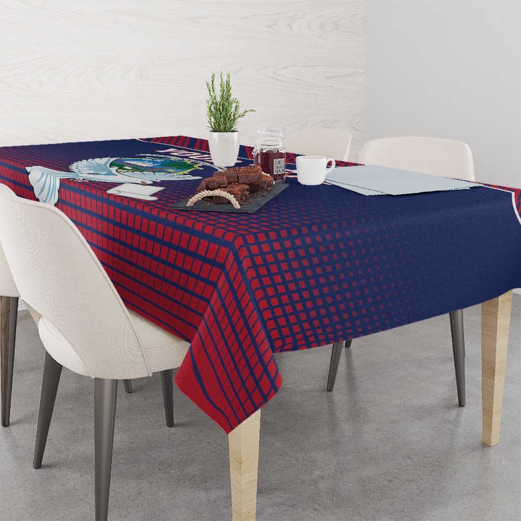 Navy and red patterned tablecloth with centered dove motif over dining table