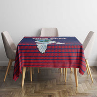 Square tablecloth with navy-red grid pattern and dove emblem in center