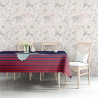Navy and red tablecloth with dove and emblem design over dining bench