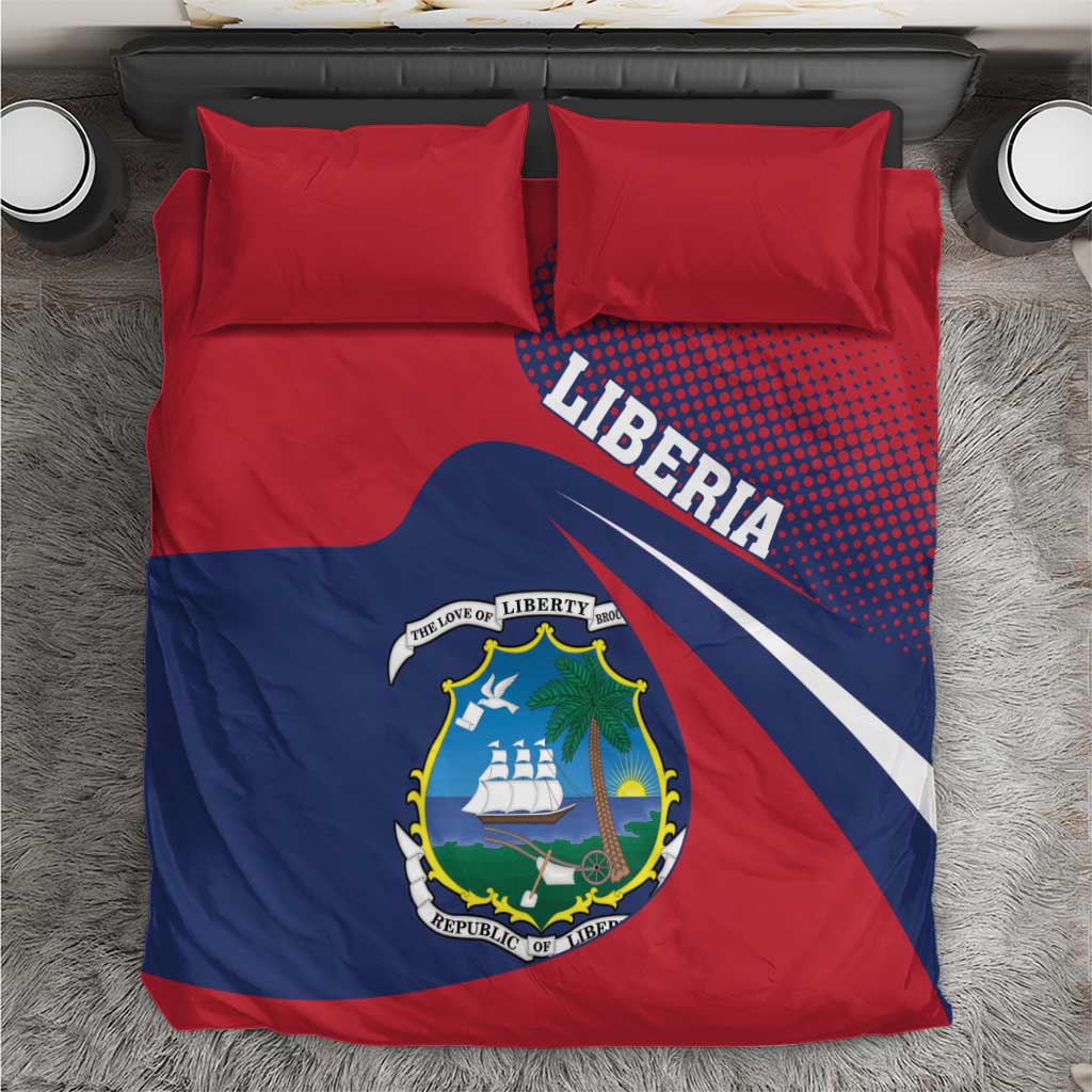Red and navy Liberia bedding set with crest and “LIBERIA” text on duvet, two red pillows