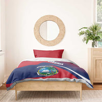 Red and navy Liberia flag duvet with crest on bed, flanked by two red pillowcases