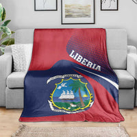 Red, navy, and white Liberia coat-of-arms blanket draped over sofa