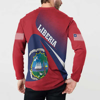 Red long-sleeve henley back view with Liberia text, crest shield, and striped sleeve flags.