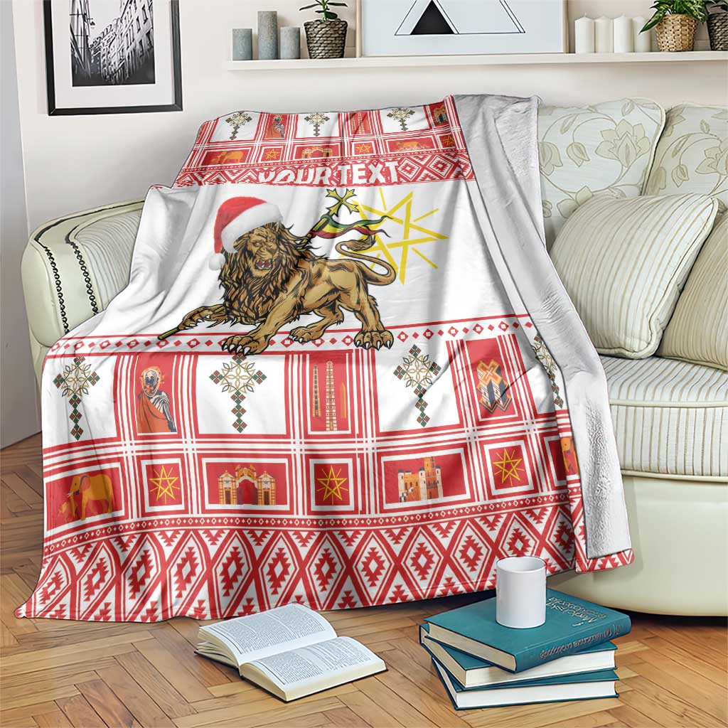 Red and white plaid Christmas blanket with lion graphic and Santa hat, draped over sofa