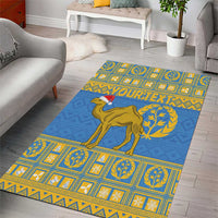 Blue area rug with gold camel, laurel emblem, and yellow border tiles