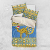Blue bedding set with gold geometric panels, camel with Santa hat, and striped pillowcases