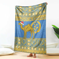 Blue wall-hanging blanket featuring camel with Santa hat and yellow emblem border