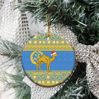 Blue circular Eritrea Christmas ceramic ornament hanging on a tree with gold camel