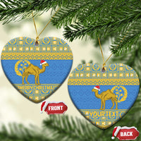 Blue heart-shaped Eritrea Christmas ceramic ornament with gold camel and “MERRY CHRISTMAS”