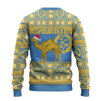 Light blue ugly Christmas sweater with gold pattern, camel graphic and 'YOUR TEXT' on back