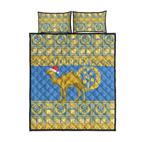 Blue quilt bed set with camel-and-laurel emblem and gold geometric border, with matching pillows