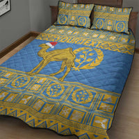 Blue quilt bed set with camel-and-laurel artwork and gold border, plus two matching pillows