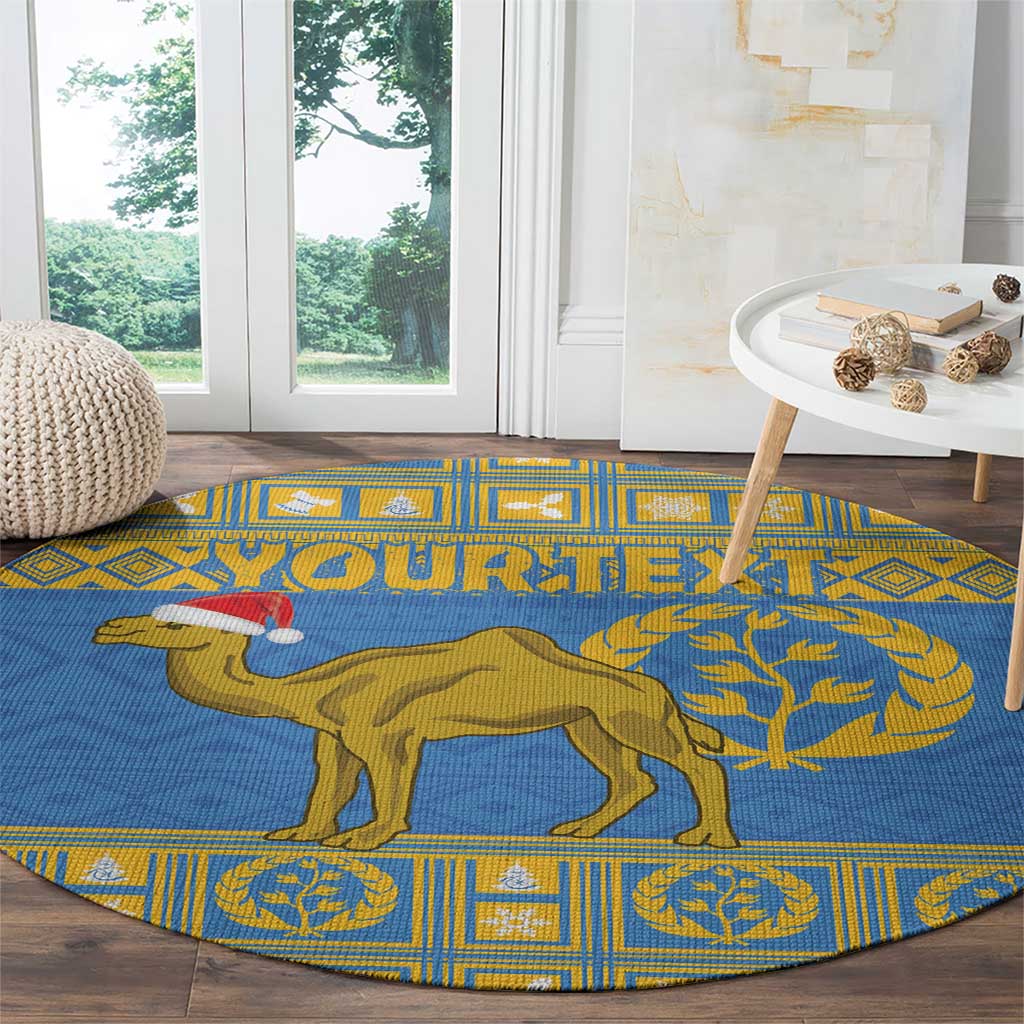 Blue round rug with gold camel and tree graphic on a patterned frame
