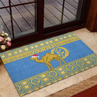 Blue rubber doormat with yellow geometric frame, camel graphic and 'YOURTEXT' near door