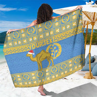 Blue sarong fabric with gold border, emblem tiles, and central camel graphic