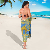 Blue and gold sarong with central camel emblem panel, tied at waist, back view