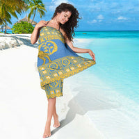 Blue sarong with gold geometric border and camel emblem, worn at the waist