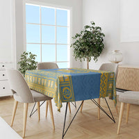 Blue tablecloth with yellow geometric border and centered national emblem