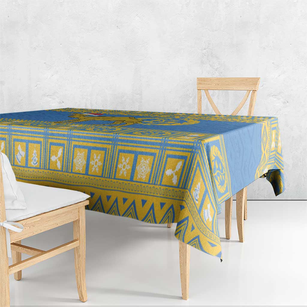 Blue tablecloth with yellow geometric striping and centered emblem design