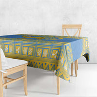 Blue tablecloth with yellow geometric striping and centered emblem design