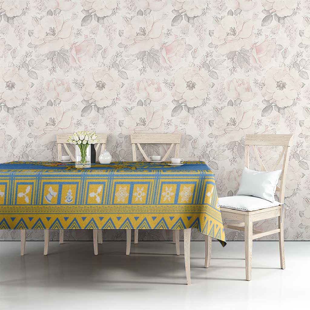 Blue tablecloth with yellow border, geometric pattern, and emblem center panel
