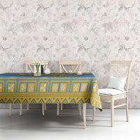 Blue tablecloth with yellow border, geometric pattern, and emblem center panel