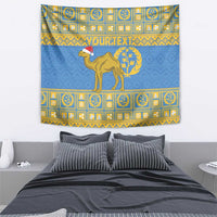 Blue tapestry featuring centered camel, red hat, and gold laurel wreath