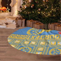 Blue Christmas tree skirt with gold pattern and central camel emblem