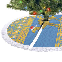 Blue and gold circular tree skirt with white fringe, camel motif and red cap