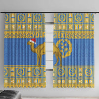 Two blue curtain panels with gold camel and circular tree emblem in grid pattern