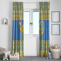 Two hanging blue curtains with gold camel and circular tree emblem, framed by window