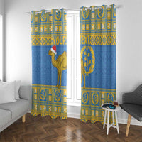 Blue curtain panels with gold camel and circular tree emblem, hung at window