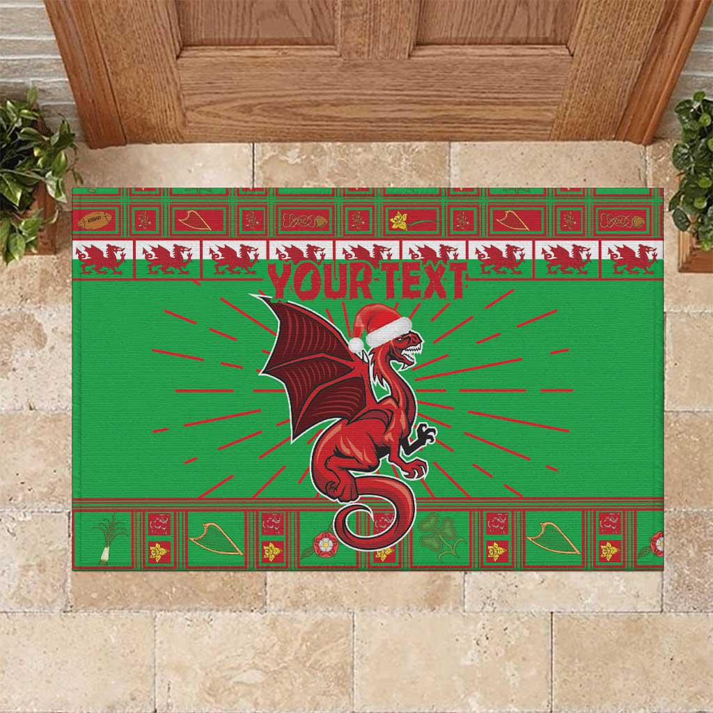 Green rubber doormat showing Welsh dragon with rays and red “YOUR TEXT” banner