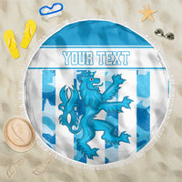 Round blue beach blanket with fringe edge, dragon graphic and center 'YOUR TEXT' area