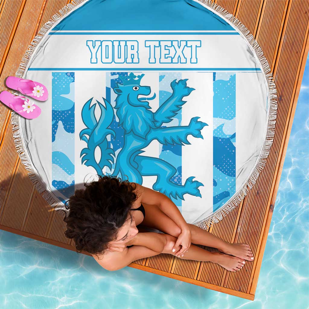 Round blue beach blanket with fringe edge, dragon graphic and 'YOUR TEXT' on mat