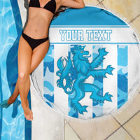Round blue beach blanket with fringe edge, dragon graphic and 'YOUR TEXT' on pool tiles