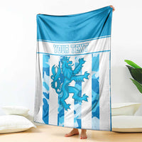 Personalized Luxembourg blanket draped on floor, blue and white striped crest with “YOUR TEXT”