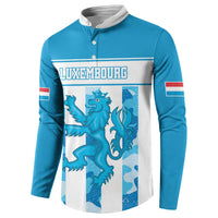 Blue button sweatshirt with large Luxembourg crest graphic and striped sleeve details