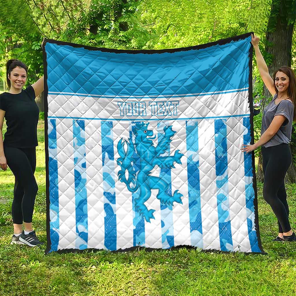 Large blue and white quilt featuring striped pattern, dragon emblem, and custom text