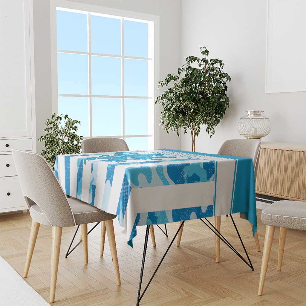 Blue patterned tablecloth draped over a rectangular dining table