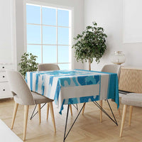 Blue patterned tablecloth draped over a rectangular dining table