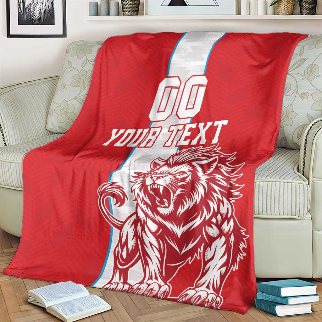 Red sports blanket on sofa back; white vertical stripe, YOUR TEXT, roaring lion