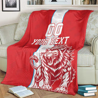 Red sports blanket on sofa back; white vertical stripe, YOUR TEXT, roaring lion