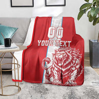 Red football blanket on gray chair; white stripe with YOUR TEXT and lion artwork