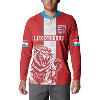 Red football button sweatshirt with blue collar, Luxembourg crest, lion graphic front