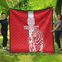Red quilt with white center stripe, lion graphic, 'YOUR TEXT' and number 00, outdoors