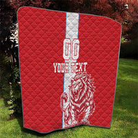 Red quilt with white stripe and lion graphic, 'YOUR TEXT' and 00, corner view