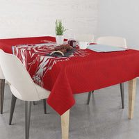 Red tablecloth with white pattern border and lion-themed artwork across the tabletop