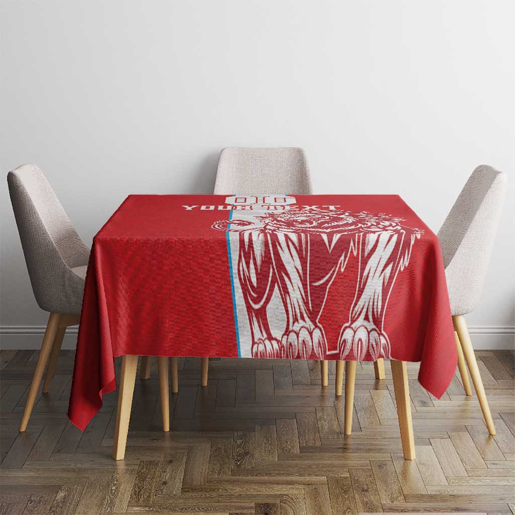 Red football tablecloth with white lion artwork on center, square table setting