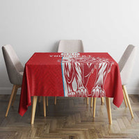 Red football tablecloth with white lion artwork on center, square table setting